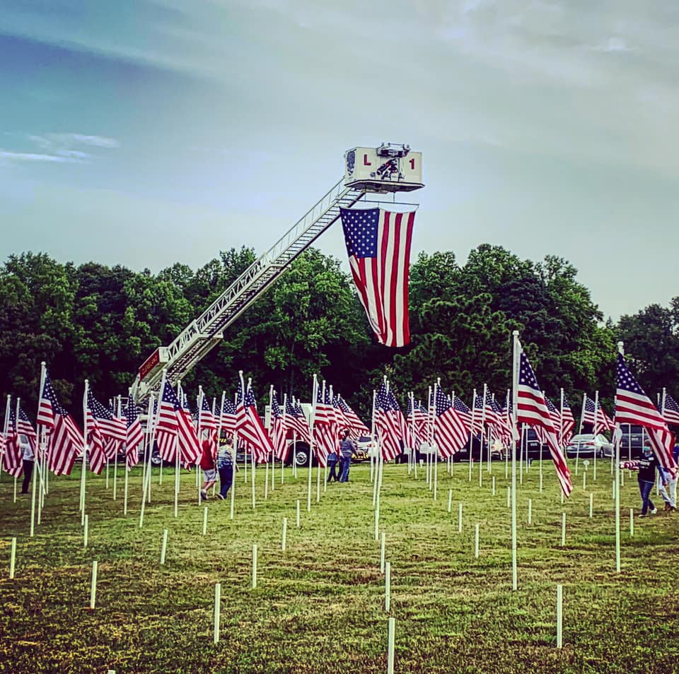 A roadside view of the installation of flags at Flags For Heroes 2020