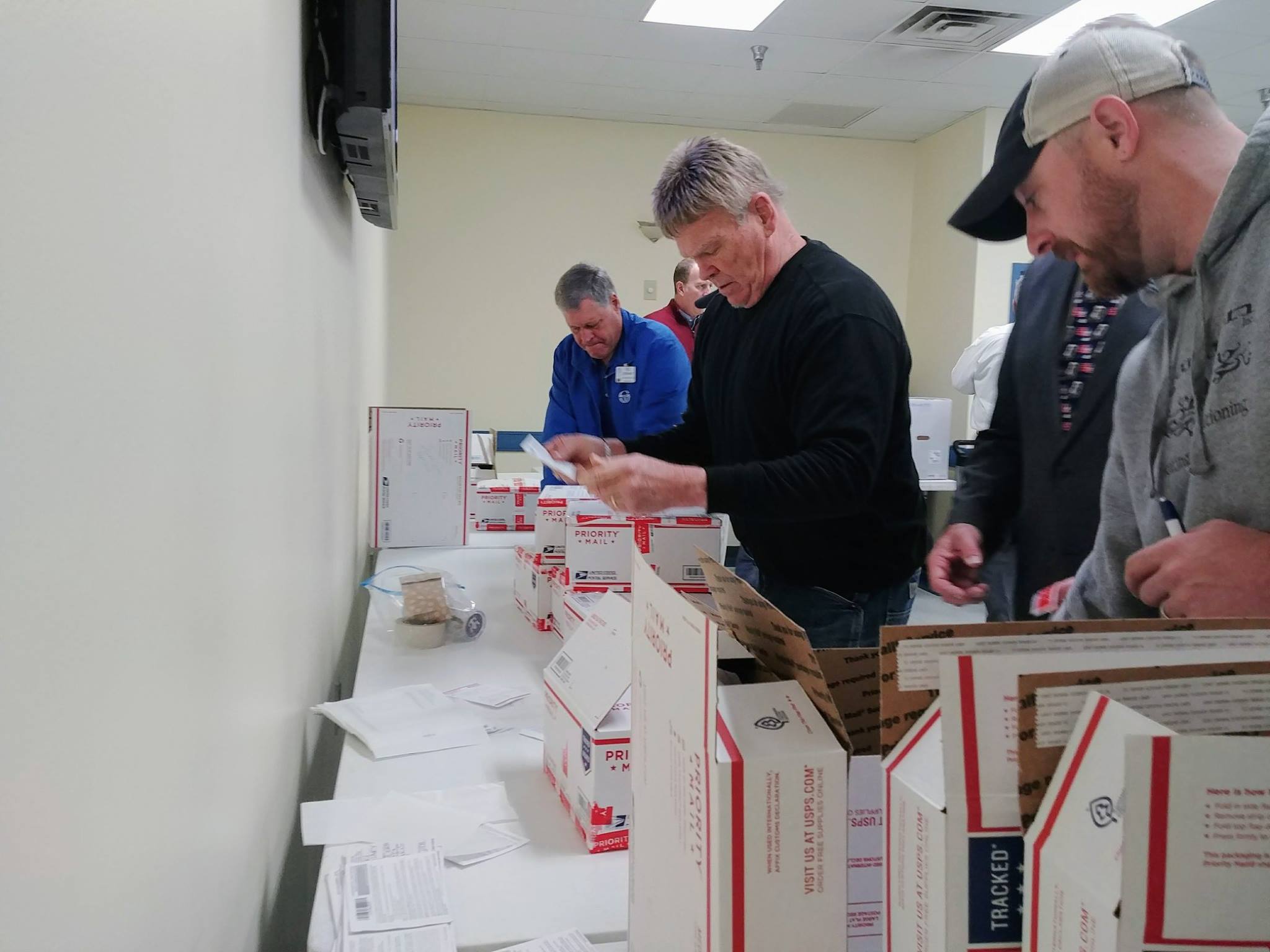 Clayton Rotarians putting on the address labels and sealing the boxes.