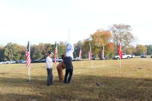 U.S. Army Veterans and family members plant the Army flag at Veterans Day tribute, November 12, 2021
